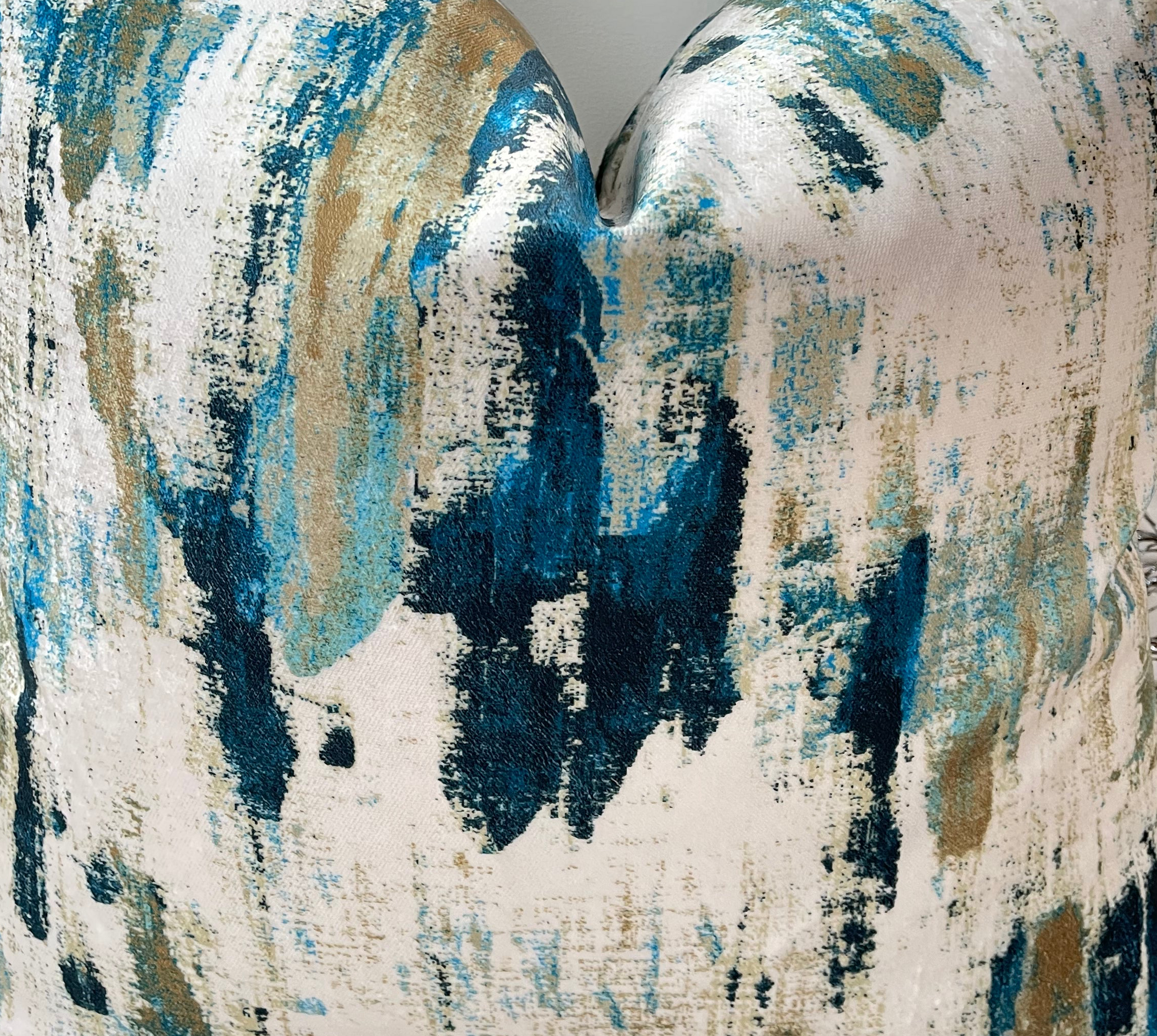 a close up of a blue and white pillow